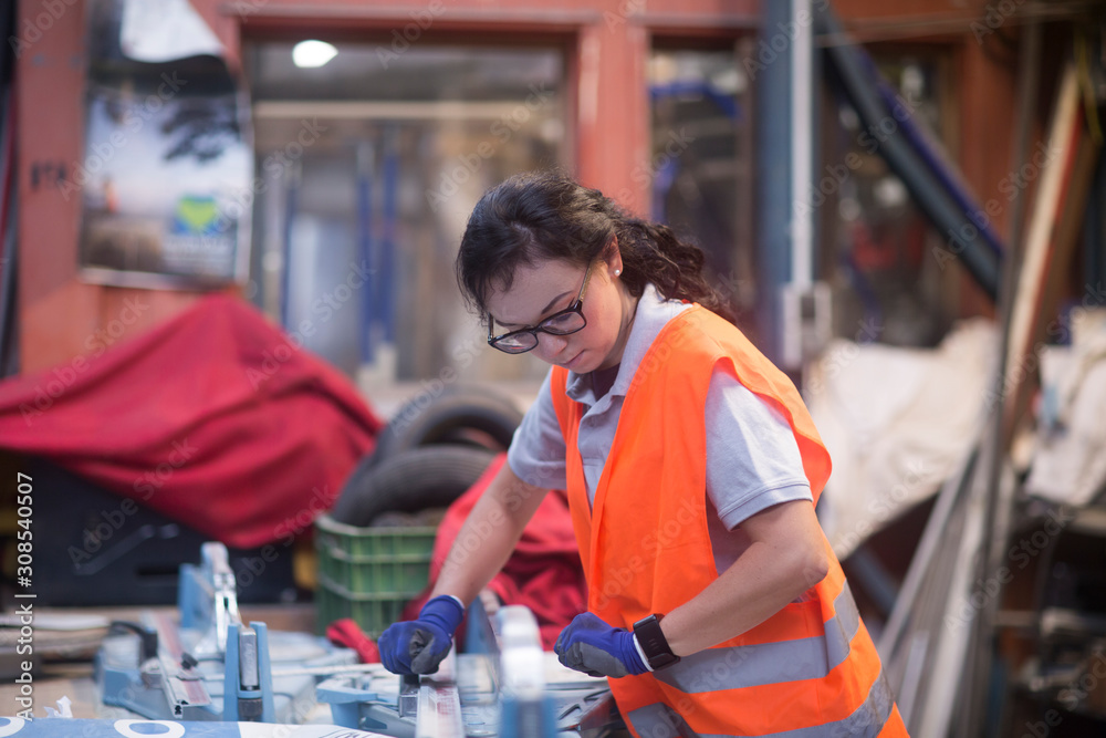 Utility Storekeeper storekeeper female in a warehouse working with a device Stock Photo ...