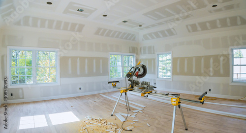 Construction remodeling home cutting wooden trim with circular saw. photo