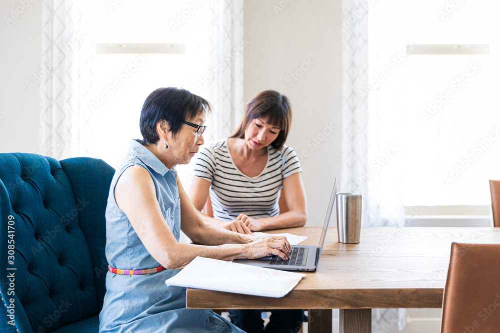 Daughter Helping Asian Mom With Paperwork Daughter Helping Asian Mom With Paperwork