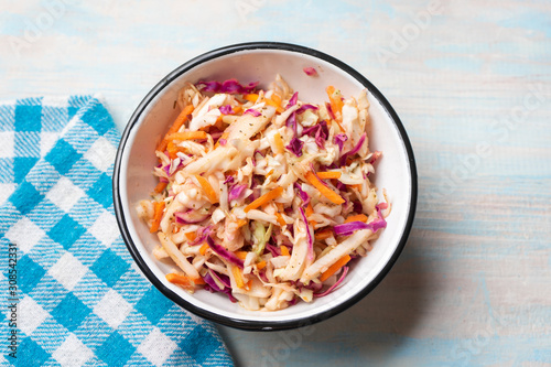 Fotografija Coleslaw with vinegar and oregano on wooden background