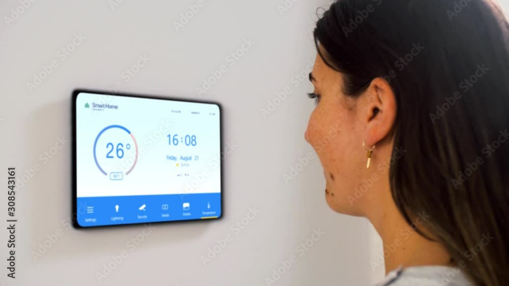 automation, internet of things and technology concept - woman setting room temperature on tablet pc computer at smart home