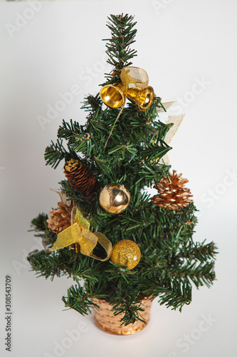 Green spruce decorated for Christmas and New Year on a white background
