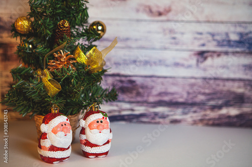 Fir tree for New Year and Christmas decorated with toys and Santa Claus.