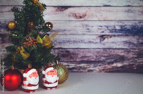 Fir tree for New Year and Christmas decorated with toys and Santa Claus.