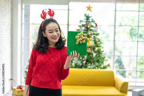 Portrait of Woman Holding Gift Box for Merry Christmas and Happy New Year.