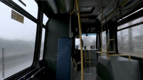 view from an empty passenger bus interior moving in rainy, foggy day