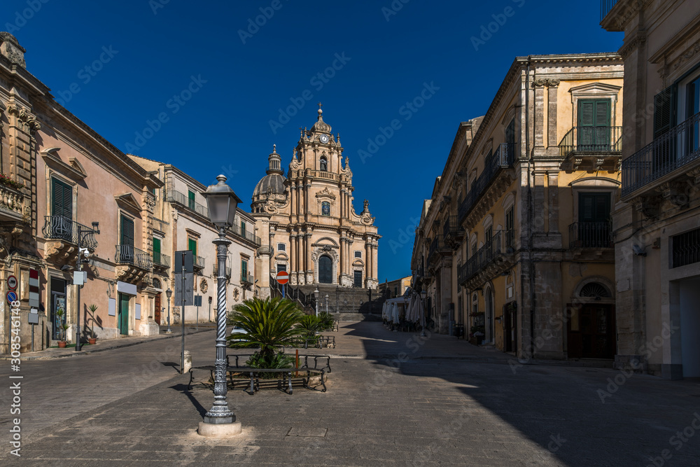 View of the baroque church San Giorgio and the empty square Piazza Duomo in the historical center of Ragusa Ibla in Sicily, Italy