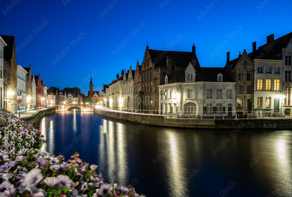 An evening blue hour scene along the canals of Bruges, Belgium An evening blue hour scene along the canals of Bruges, Belgium
