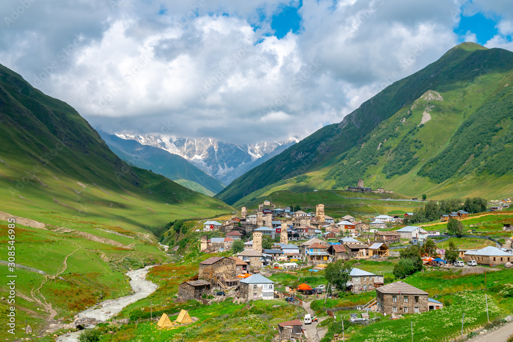 View of the Ushguli village at the foot of Mt. Shkhara. Picturesque and gorgeous scene. Rock towers and old houses in Ushguli, Georgia.