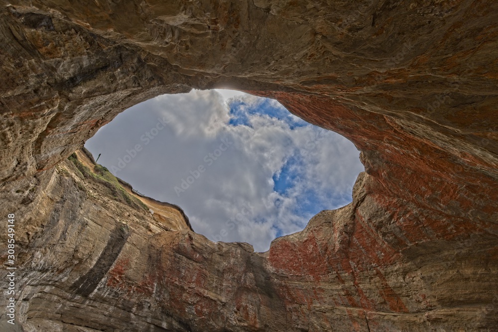 Looking through the hole in the roof at the sky from within Devils Punchbowl Oregon