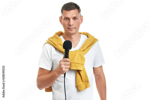 Male journalist with microphone on white background