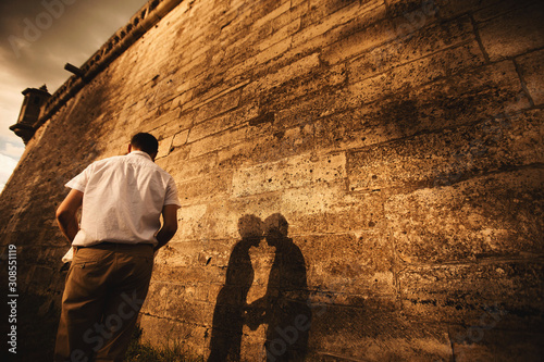 A wonderful love story. Young couple walking around the old wall of castle