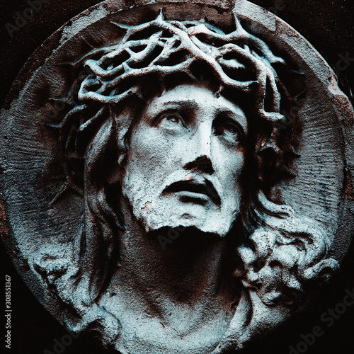 Jesus Christ in a crown of thorns. Fragment of ancient statue.