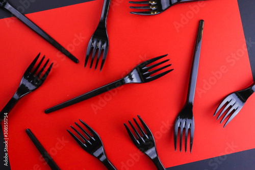 Foto Black forks on red background.