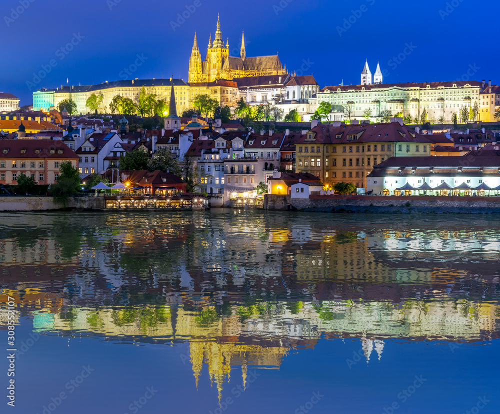 Prague Castle with St. Vitus Cathedral over Lesser town (Mala Strana) reflected in Vltava river, Czech Republic