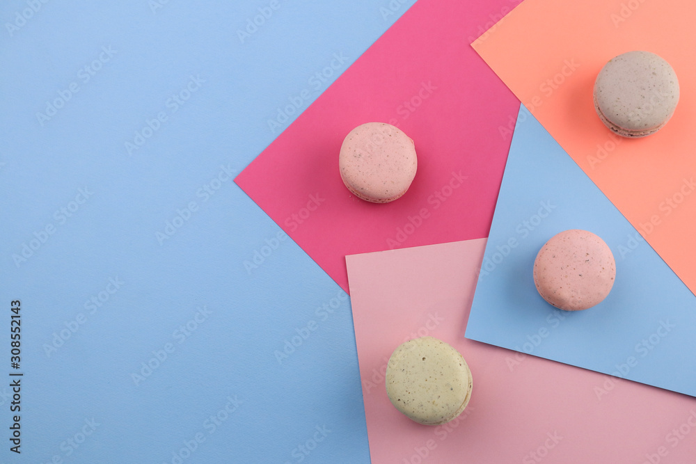 Fototapeta premium Tasty sweet macaron cakes on color background