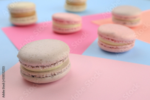 Tasty sweet macaron cakes on color background