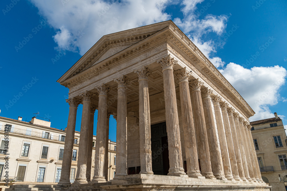 Maison Carree - restored roman temple dedicated to princes of youth, with richly decorated columns and friezes in Nimes, France