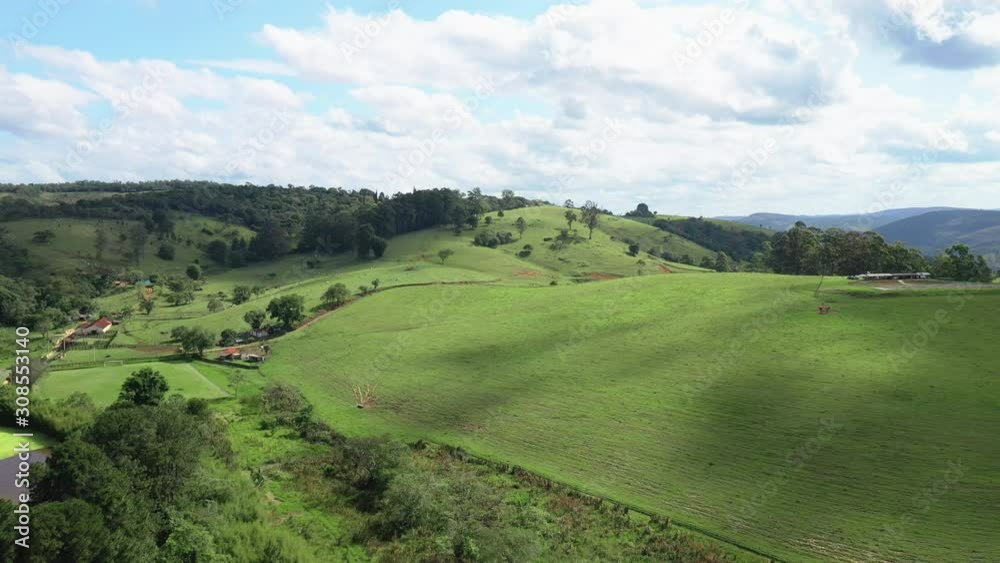 Beautiful aerial scenic panoramic view of rolling countryside green farm fields and forests