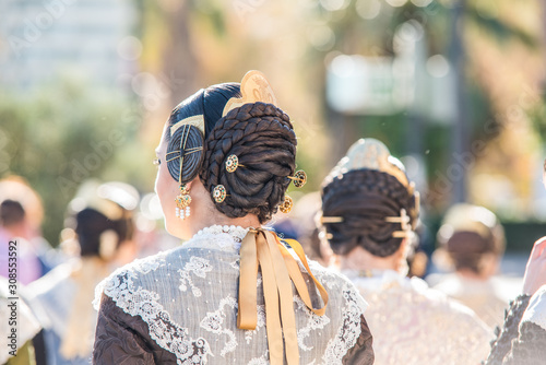 Fallera hairstyle detail, typical celebration of Valencia on a sunny day photo