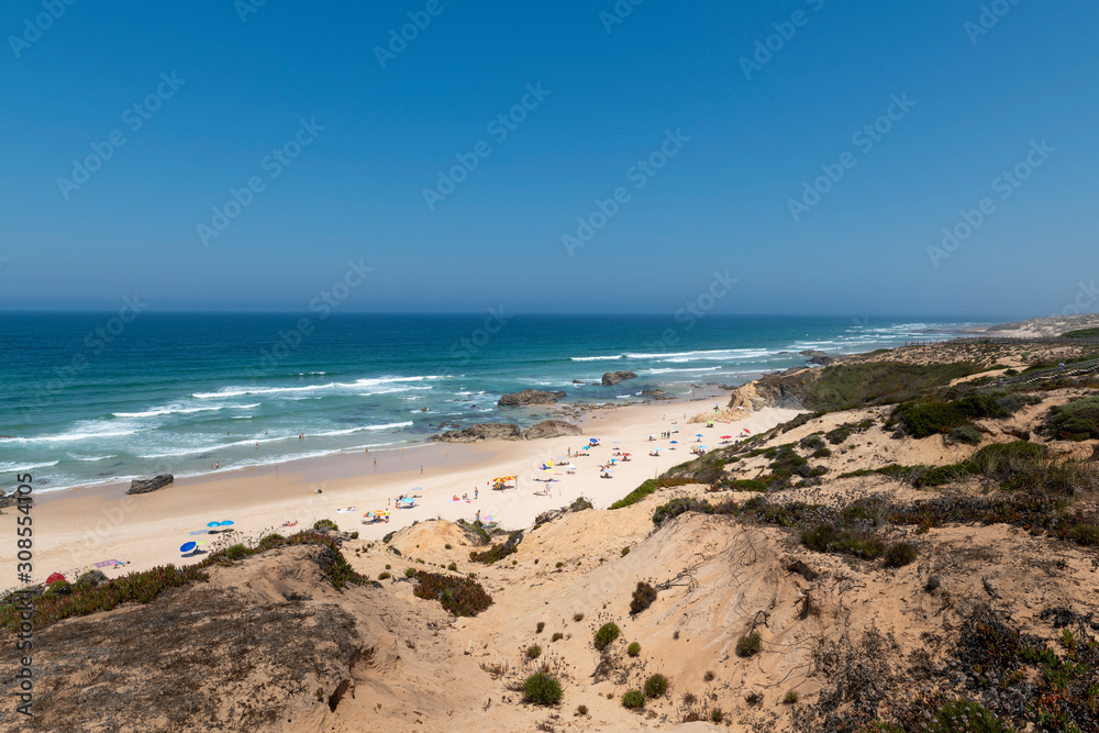 People at the Malhao Beach (Praia do Malhao) in Porto Covo, in Alentejo, Portugal.