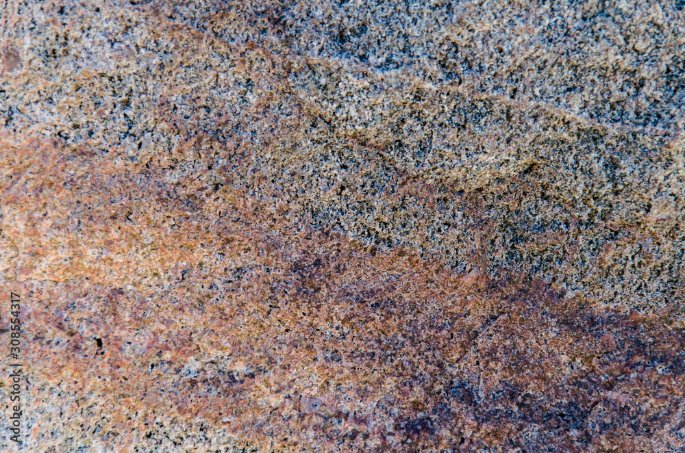 Fototapeta premium Granite background. The wall of the old building. Close-up.