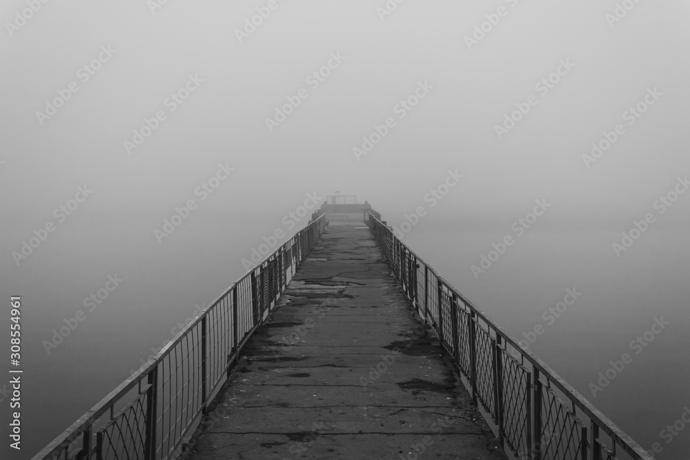 Old abandoned pier in the fog