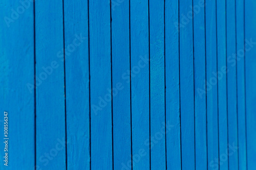 blue background with vertical lines. metal fence