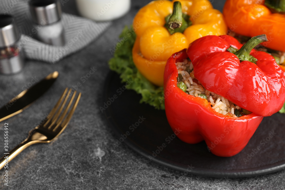 Tasty stuffed bell peppers on grey table, closeup