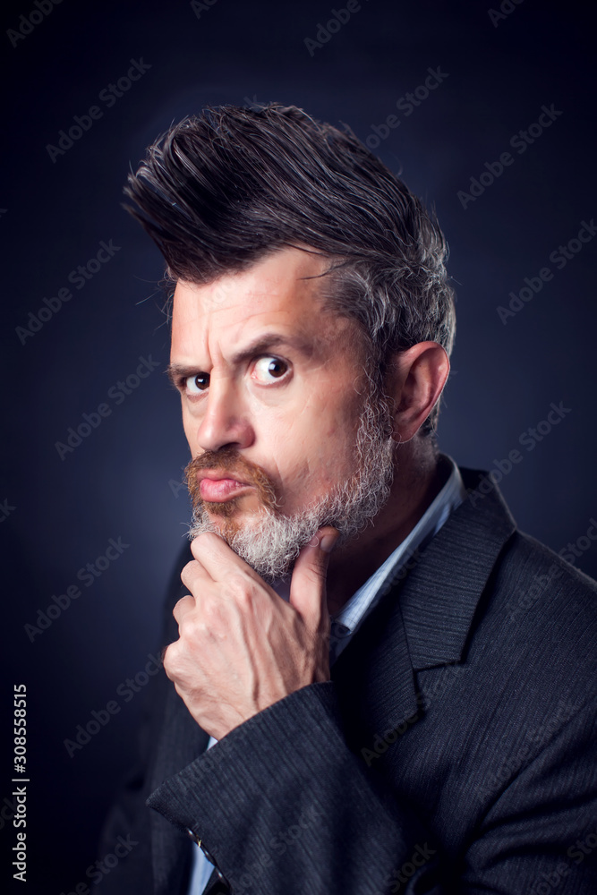 A portrait of bearded man with iroquois wearing suit A portrait of bearded man with iroquois wearing suit