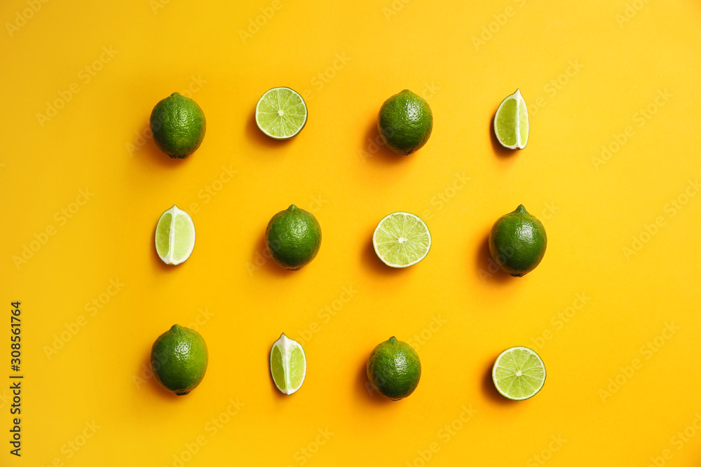 Flat lay composition with fresh juicy limes on yellow background Flat lay composition with fresh juicy limes on yellow background