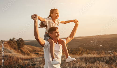 Father and daughter enjoying freedom in nature