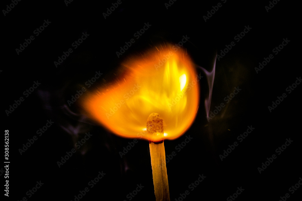 burning match on black background burning match on black background