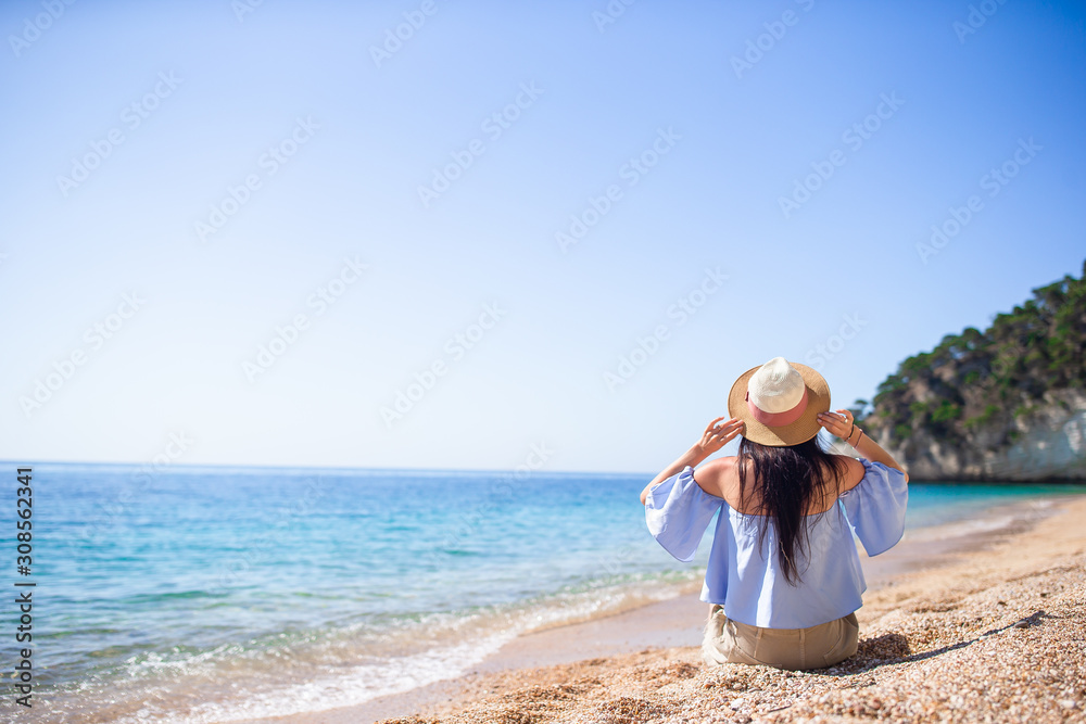 Woman laying on the beach enjoying summer holidays looking at the sea Woman laying on the beach enjoying summer holidays looking at the sea