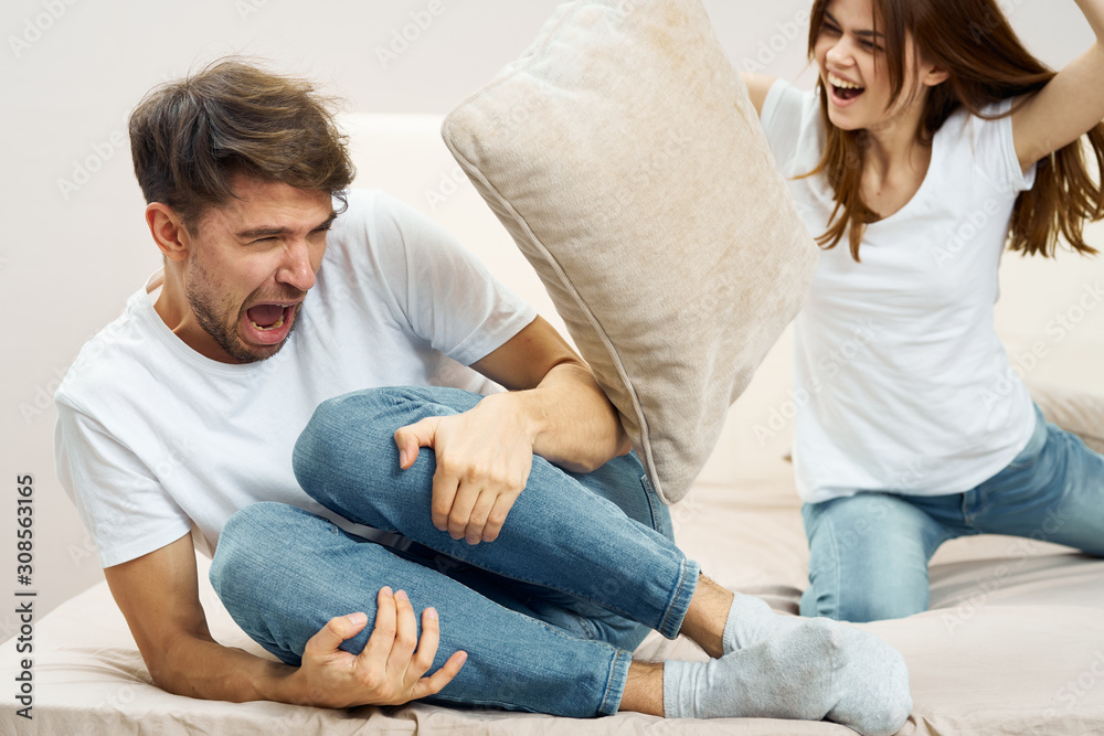 couple sitting on sofa and watching television couple sitting on sofa and watching television