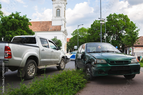 Car crash accident on the city road. Damaged automobiles after collision.