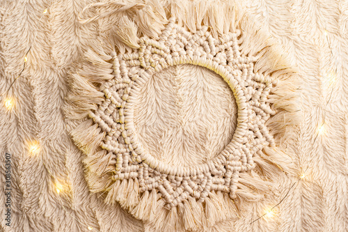 Handmade macrame  circle decoration on artificial fur. Top view.