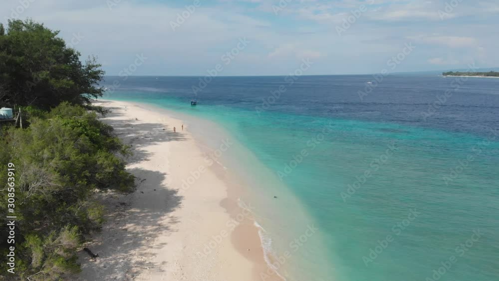 Aerial view of beach with turquoise clear ocean water and white sand beach and greenery on coastline of tropical island. Gili Meno, Indonesia Aerial view of beach with turquoise clear ocean water and white sand beach and greenery on coastline of tropical island. Gili Meno, Indonesia