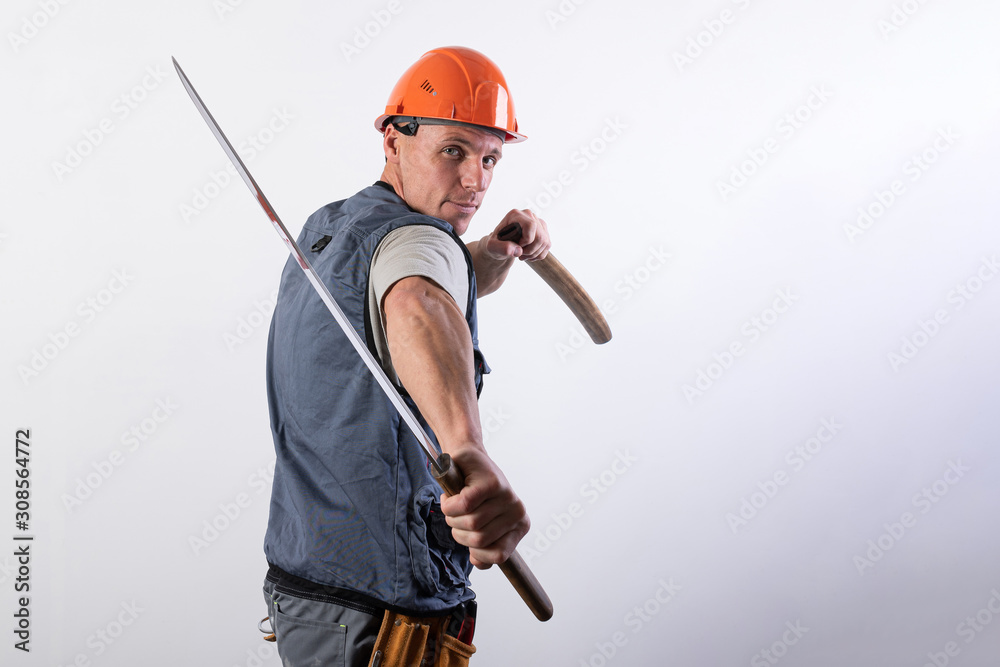 The builder shows a fight with a katana. Repairman wearing a helmet and work clothes. The builder shows a fight with a katana. Repairman wearing a helmet and work clothes.