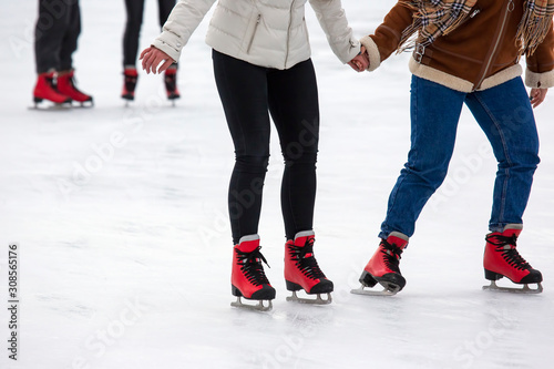 people ice skating on an ice rink. Hobbies and sports. Vacations and winter activities.