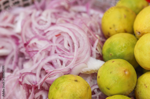 Selected focus on Yellow Lemon and Blur Onion Slices in Background