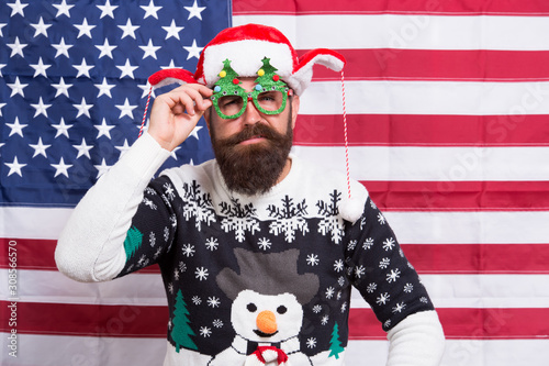 Happy holidays. Merry Christmas. Holiday season in USA. Where liberty dwells. Happy new year. Happy guy celebrate xmas and new year. Bearded hipster man happy smiling american flag background © be free