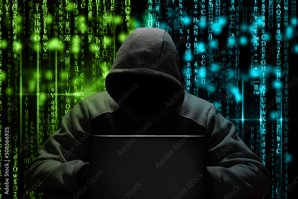 Fototapeta a computer hacker breaks a password while sitting in a dark room at a laptop. Cyber security