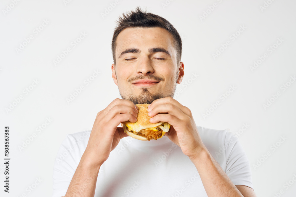 man eating hamburger man eating hamburger