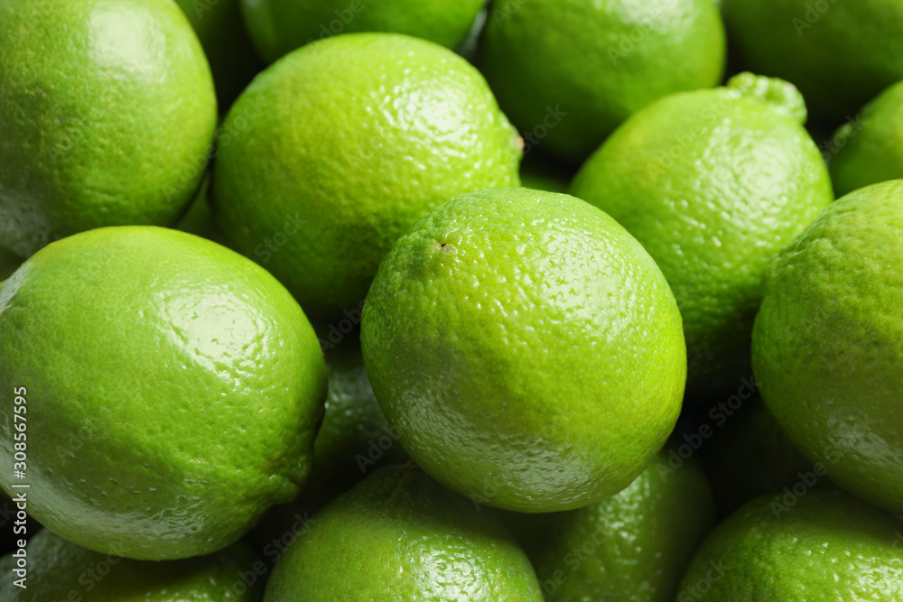 Fresh ripe green limes as background, closeup view Fresh ripe green limes as background, closeup view