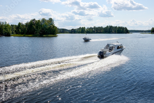 Two Fishing Boats Crossing in a Lake Saimaa, Finland on a beautiful summer day.