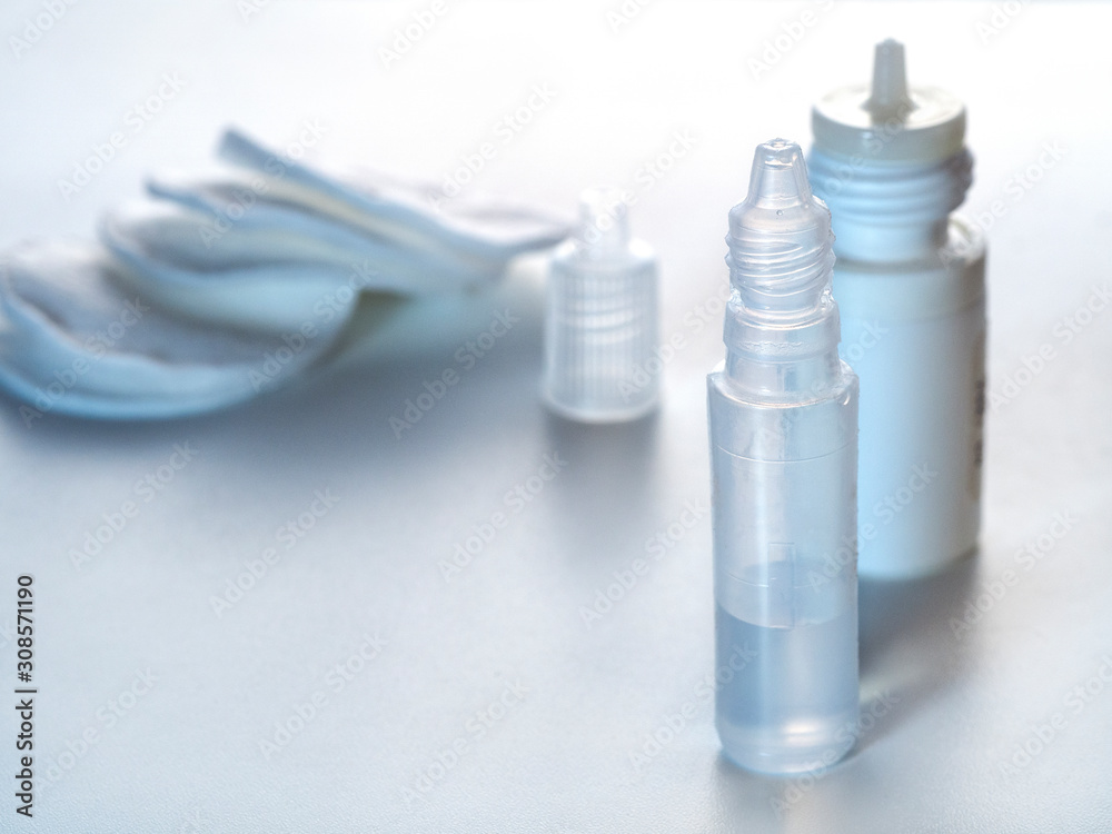 Light vertical background with eye and nasal drops. Background with medical drugs. Light vertical background with eye and nasal drops. Background with medical drugs.