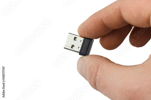 small flash drive in hand close up. Isolate 