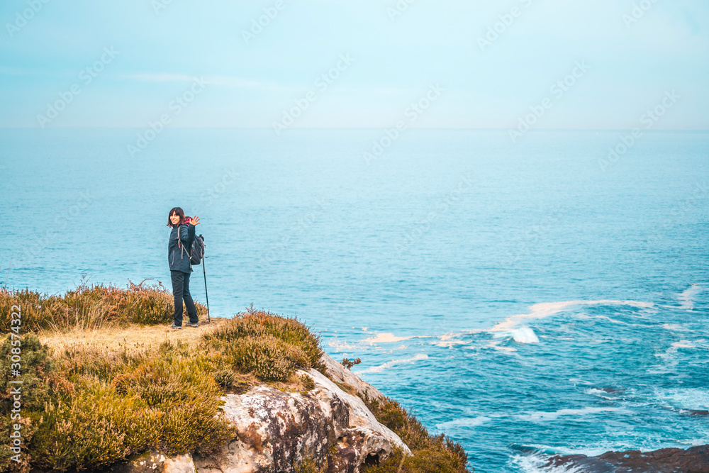 Monte Jaizkibel, Gipuzkoa / Spain »; December 6, 2019: A young woman enjoying the beautiful views of Jaizkibel