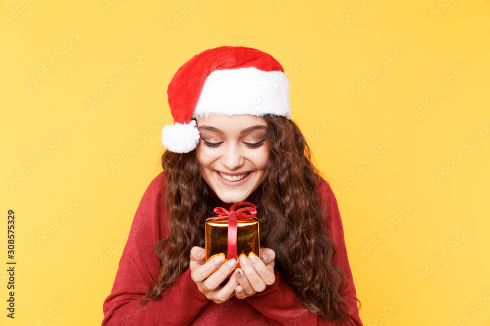 Nice happy girl holding small gift isolated Nice happy girl holding small gift isolated